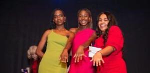 Three female students show of their rings at Ring Ceremony